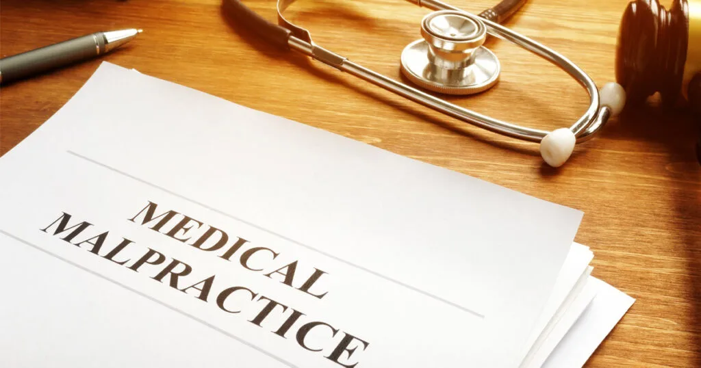 a stethoscope and a medical practice form